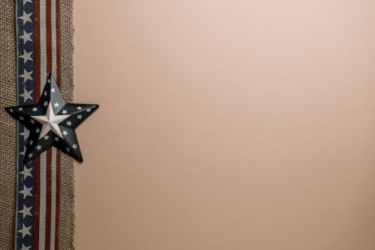 From above of star shaped badge placed on decorative ribbon with USA flag arranged on beige background