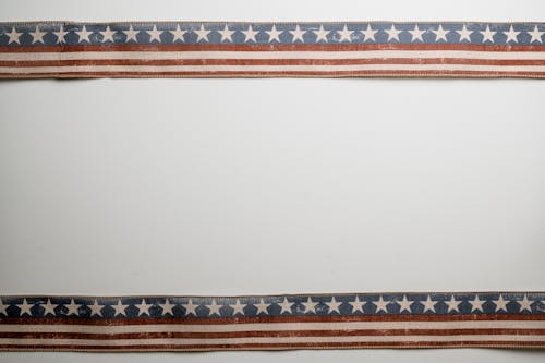 Free Ribbons with US flag pattern attached to white wall Stock Photo