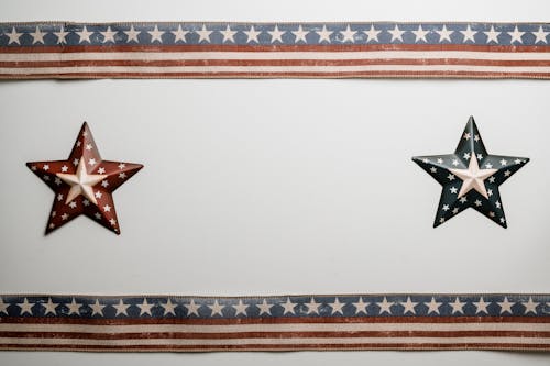 From above creative artwork with star badges and American flag ribbons attached to white surface