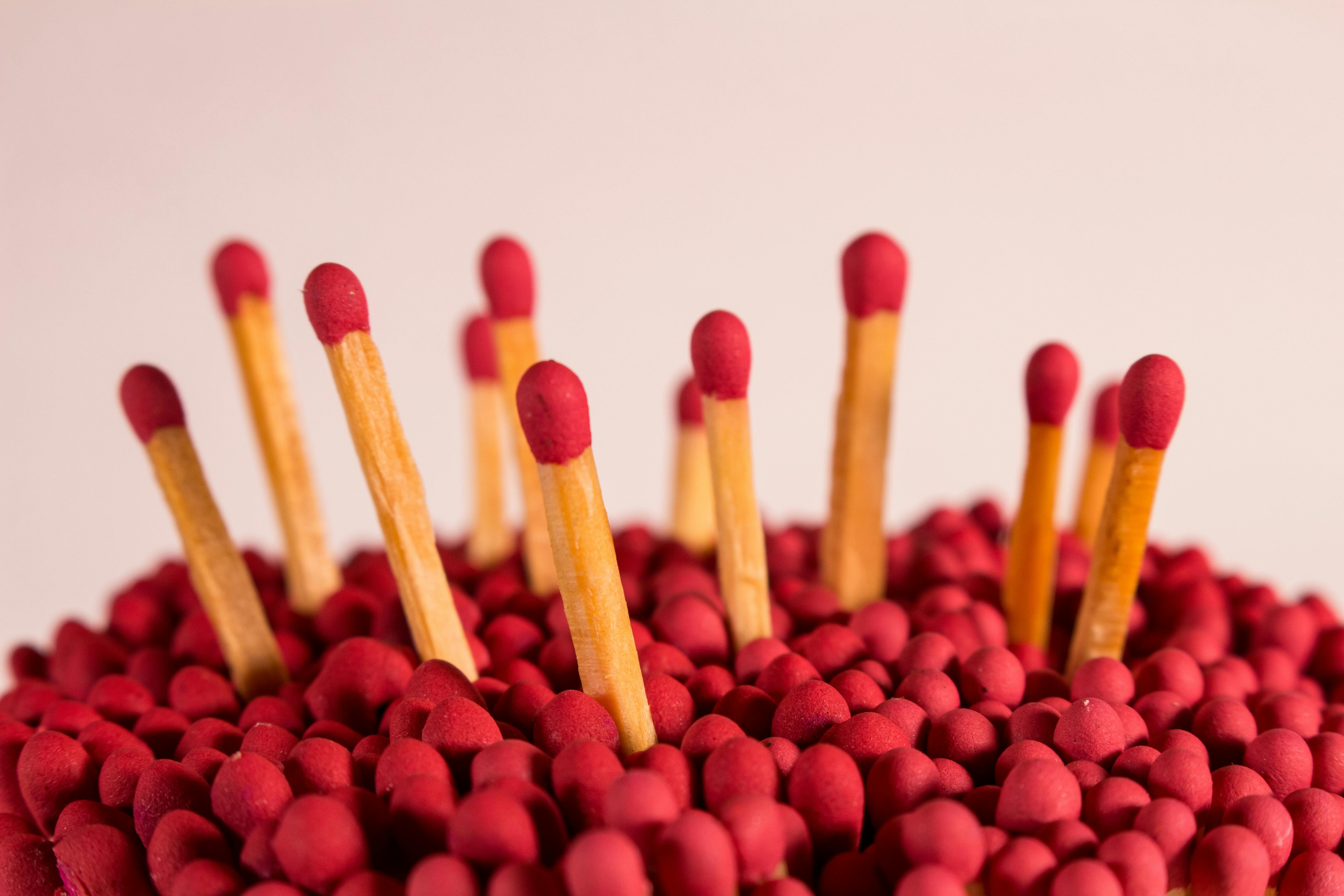 closeup of flammable redhead matches against white background