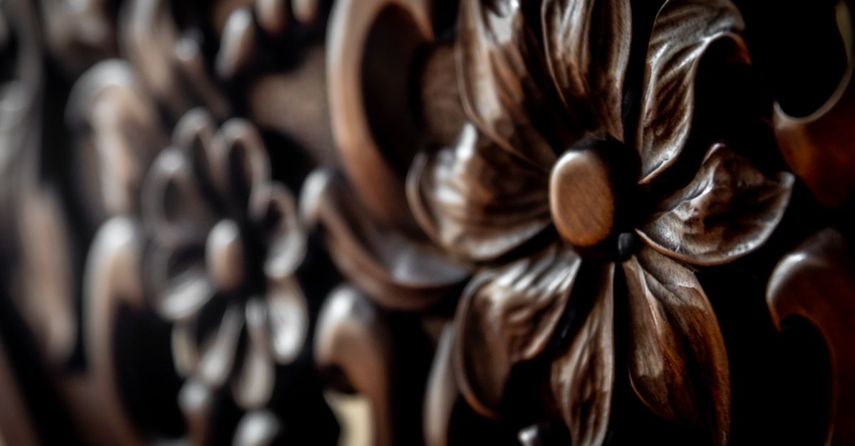 Detailed close-up of an intricately carved wooden floral pattern showcasing texture and craftsmanship.