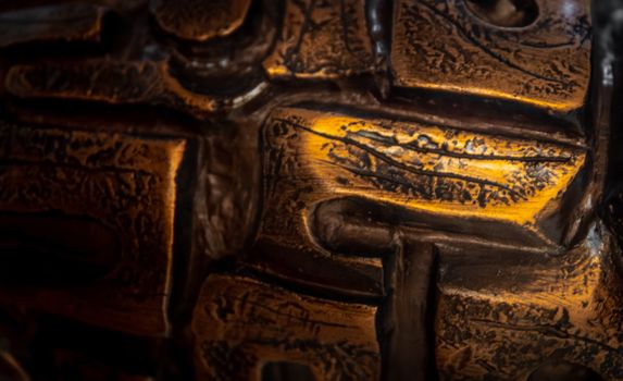Detailed close-up of gold-accented carved wooden texture, showcasing intricate patterns.