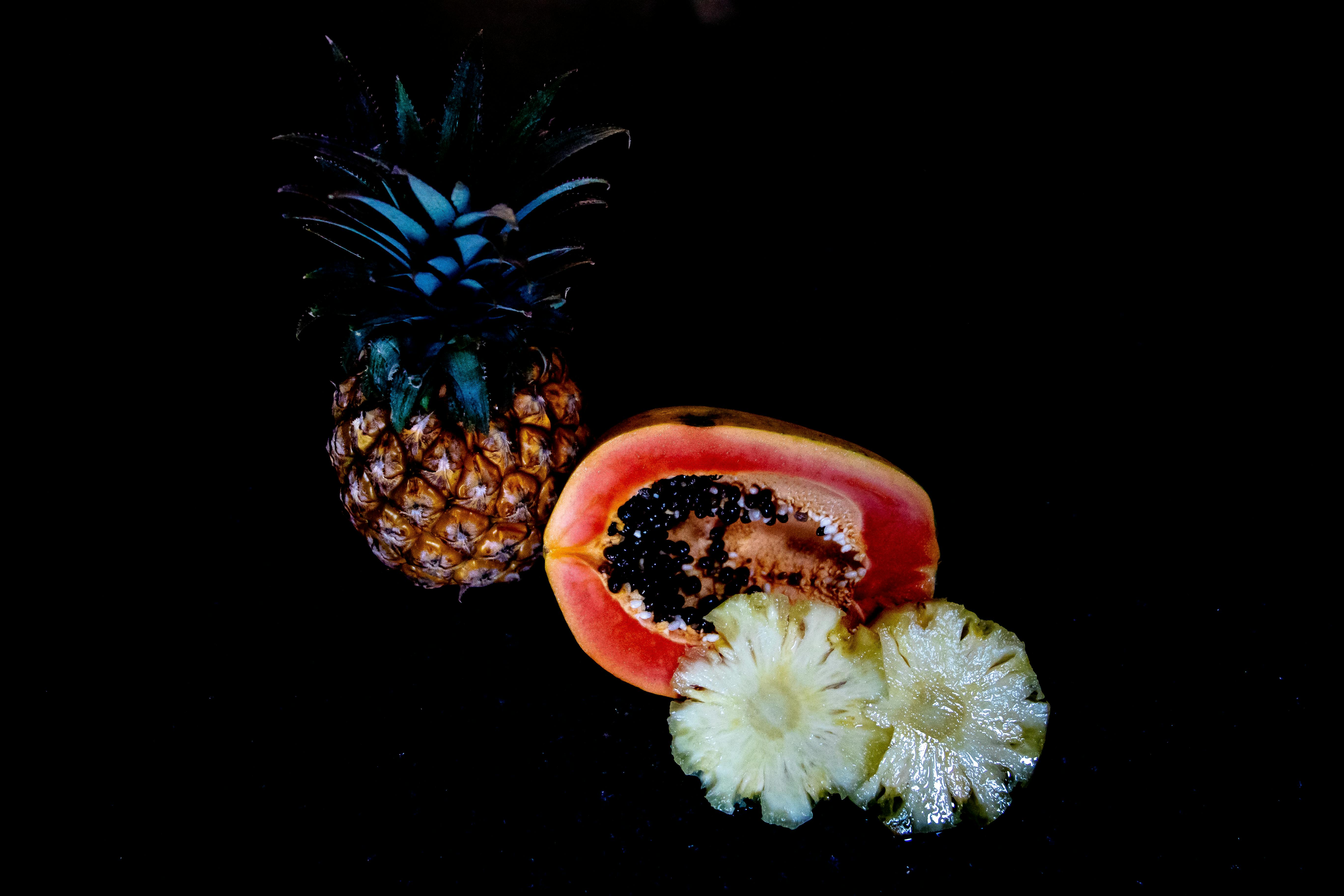 Image of a sliced pineapple and papaya, showcasing their vibrant colors and inviting textures - natural digestive aid