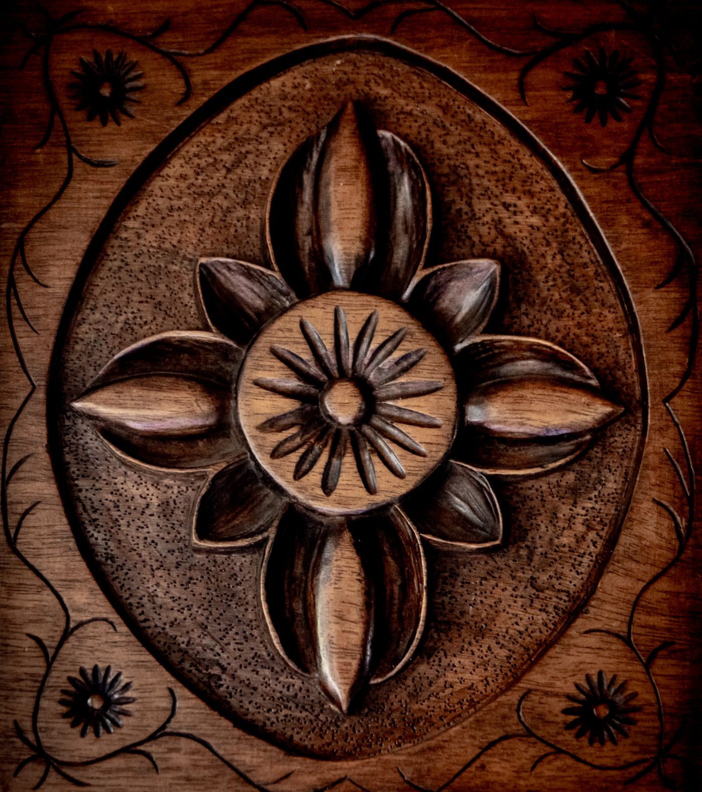 Close-up of a hand-carved floral rosette on antique wood