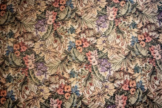 Intricate floral tapestry textile featuring a vintage design with colorful flowers and leaves.