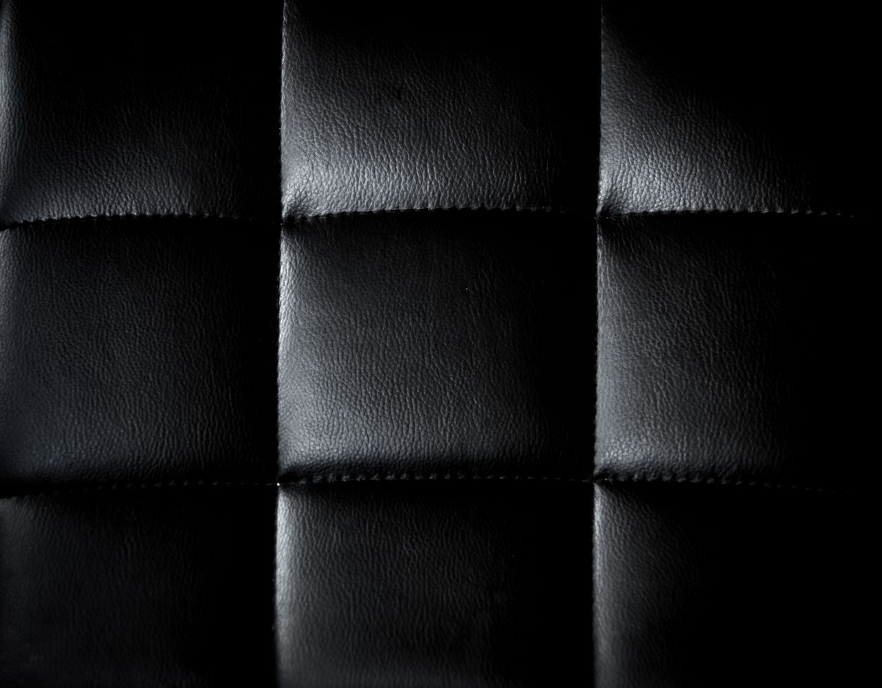 detailed close up of a black leather upholstery with a minimalist and