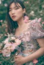 Portrait of a Young Woman in Floral Dress Holding a Flower Bouquet