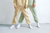 Person in Green Pants and White Shoes