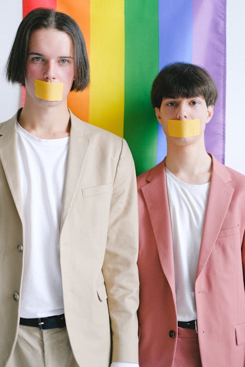 Two Men With Adhesive Tape Over Their Mouth