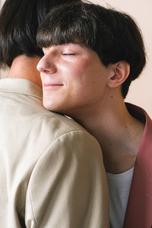 Man With his Eyes Closed Being Hugged