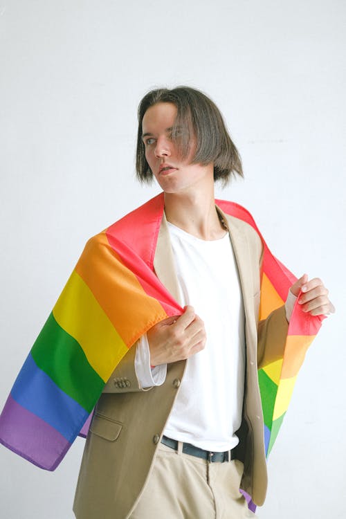 Free Man Holding a Gay Pride Flag Stock Photo