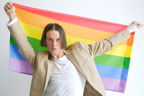 Free Man Holding a Gay Pride Flag Stock Photo