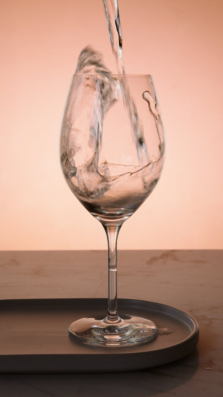 Pouring Liquid On Clear Wine Glass