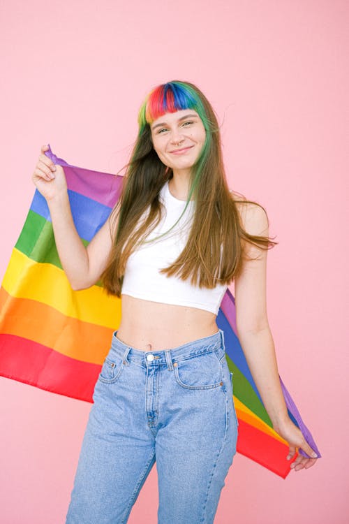 Smiling Woman Holding a Gay Pride Flag