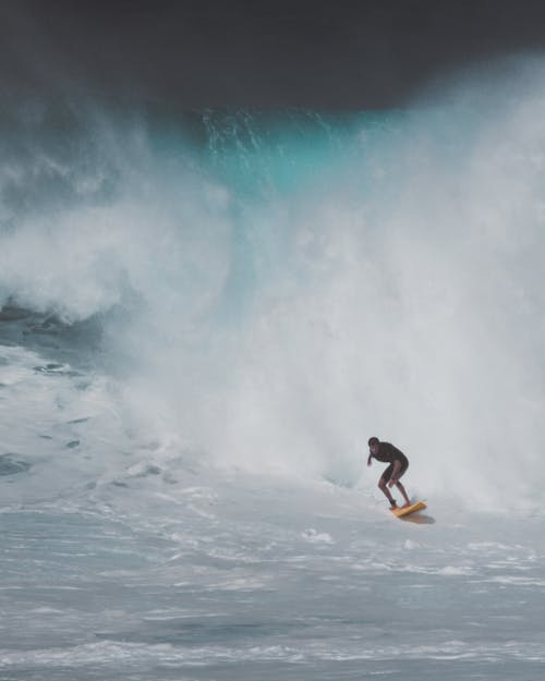 Free Man Surfing on Sea Waves Stock Photo