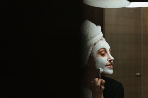 Person Holding White Towel on Head