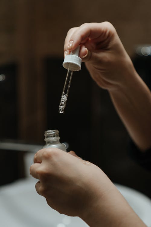 Free Person Holding White Plastic Bottle Stock Photo