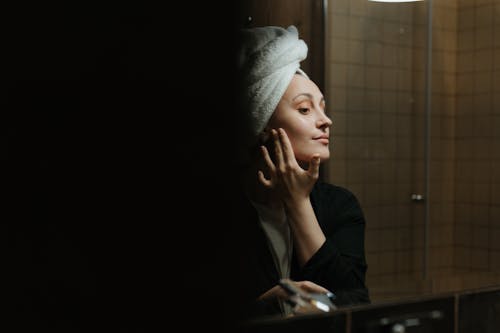 Woman in White Hijab Covering Her Face With White Towel