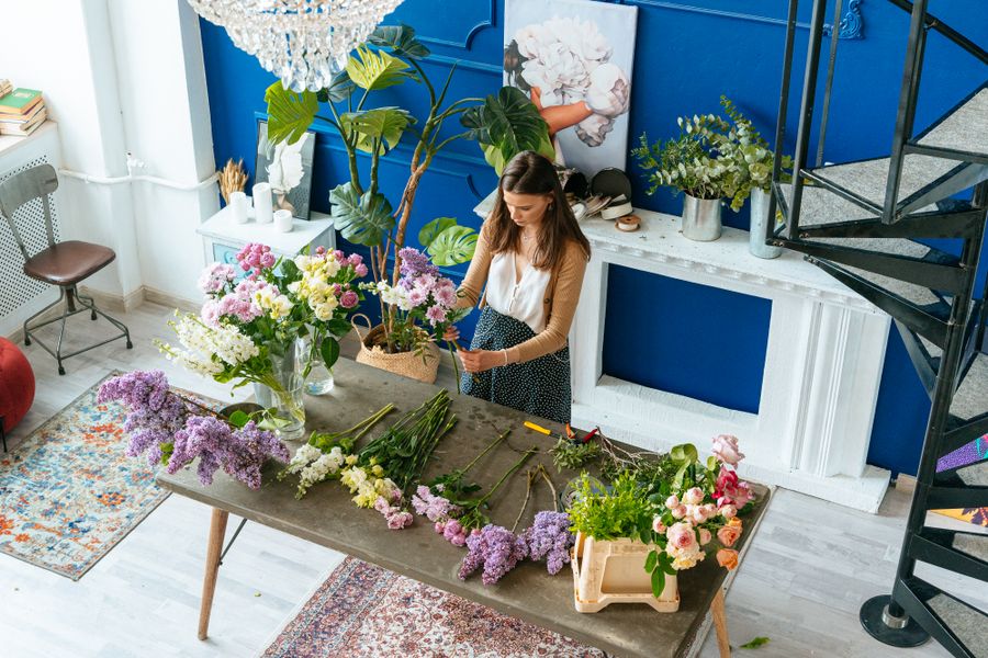 A florist arranging a fresh bouquet by hand
