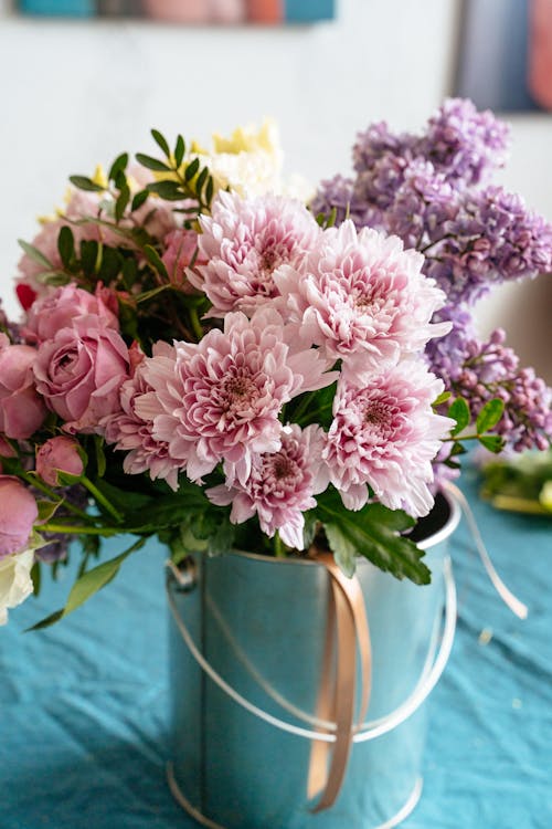 Pink and White Flowers in Green Ceramic Vase