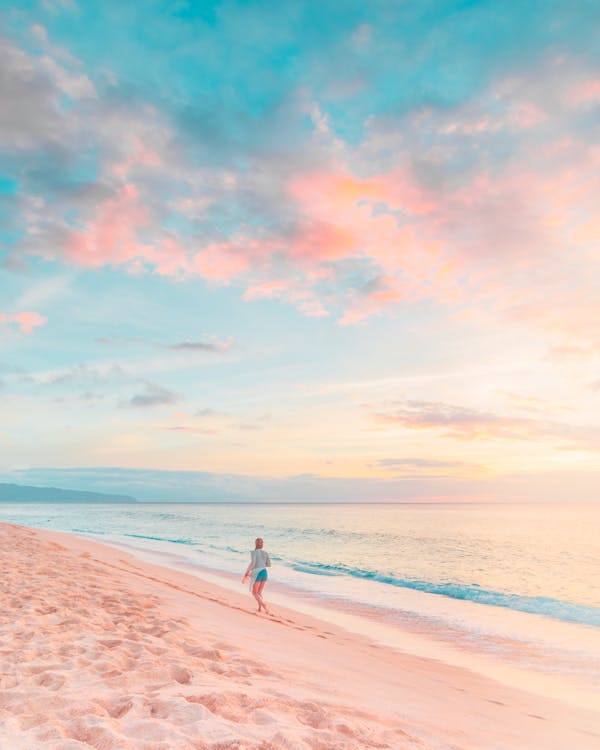 Free Woman in White Shirt Walking on Beach during Sunset Stock Photo