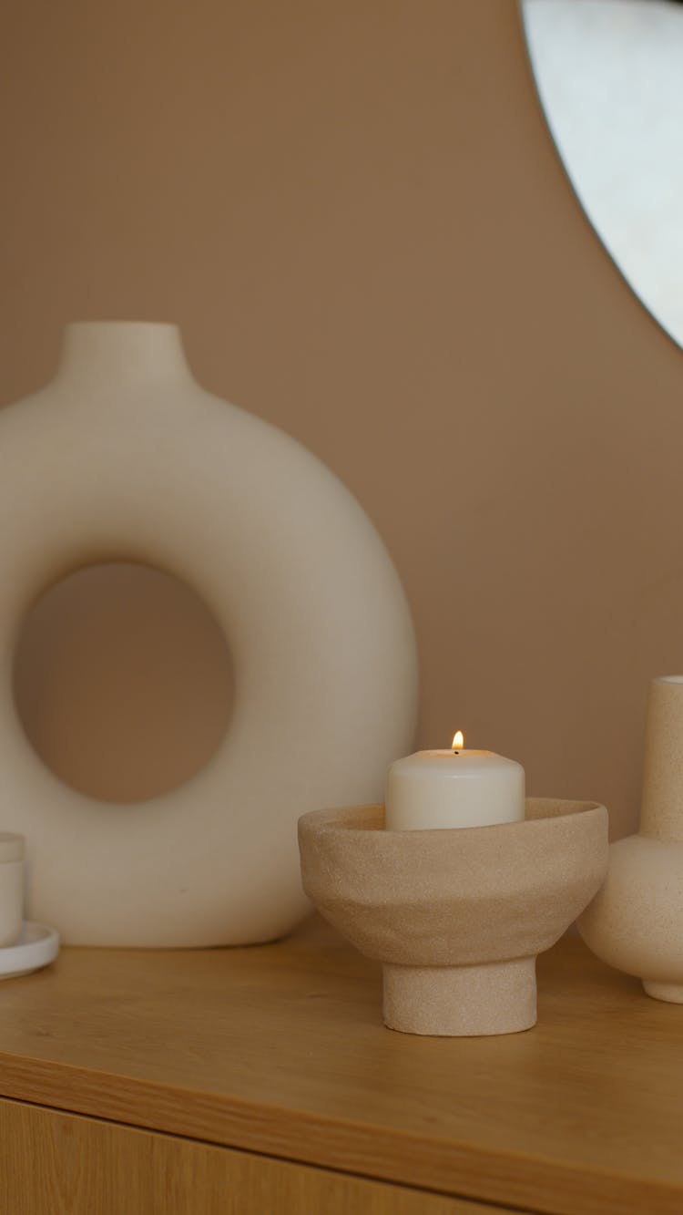 White Lighted Pillar Candle On Wooden Table