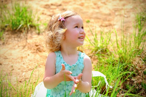 Happy little girl playing in nature