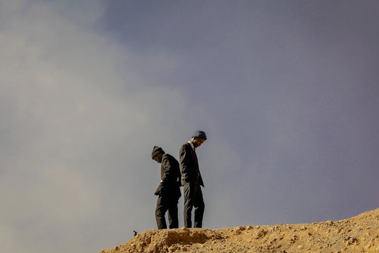 Black Men Standing On Top Of Hill