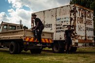Black men and freight rusty transport