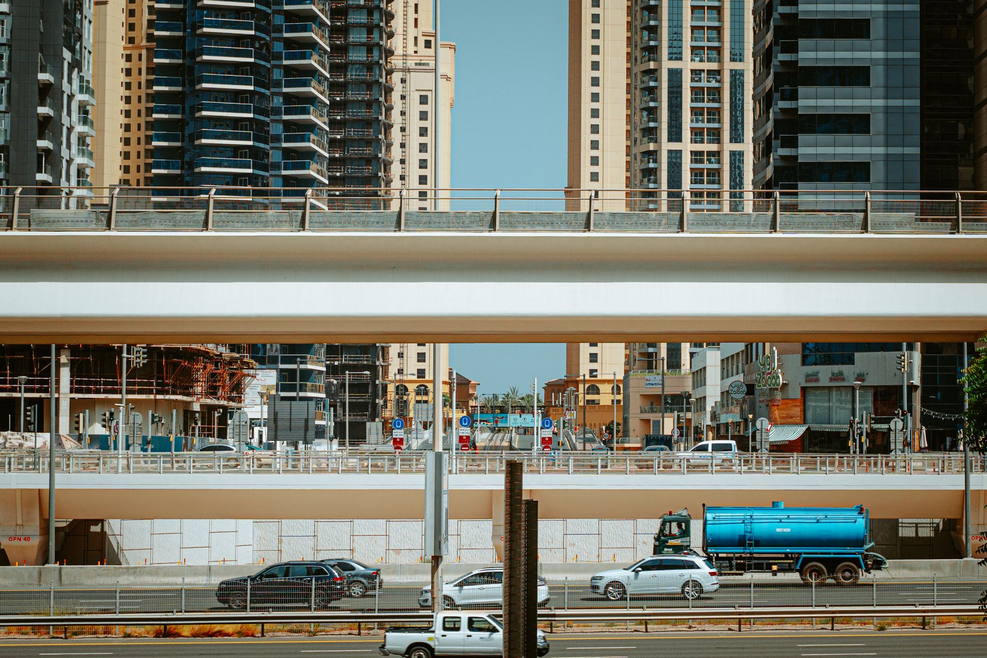 Dynamic urban scene in Dubai featuring skyscrapers and expressways.