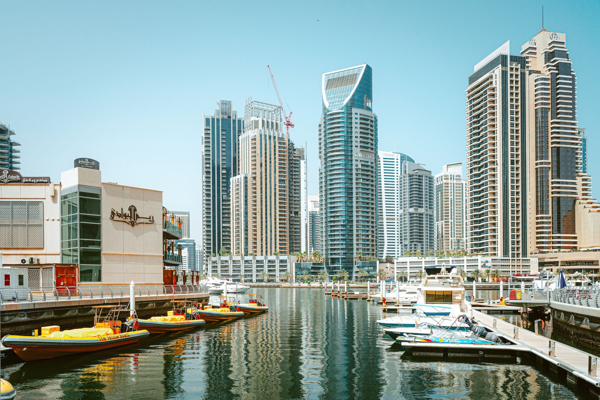 Stunning view of Dubai Marina's skyscrapers reflecting on the tranquil water.