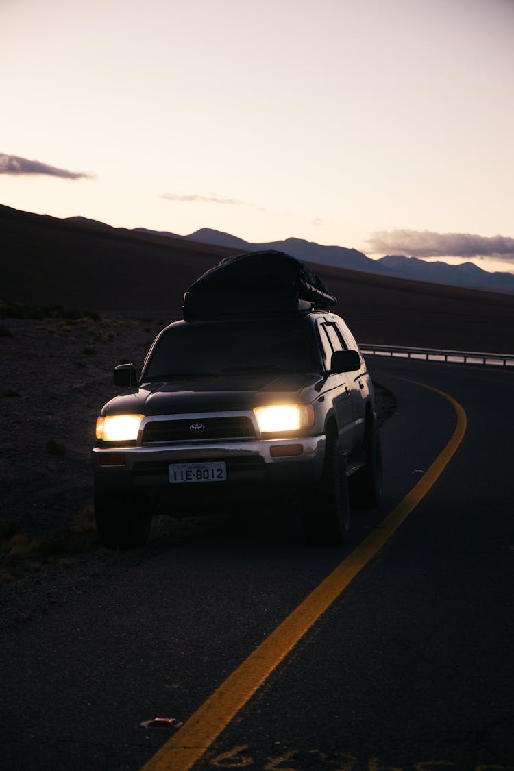 
A Car With The Head Lights Turned On