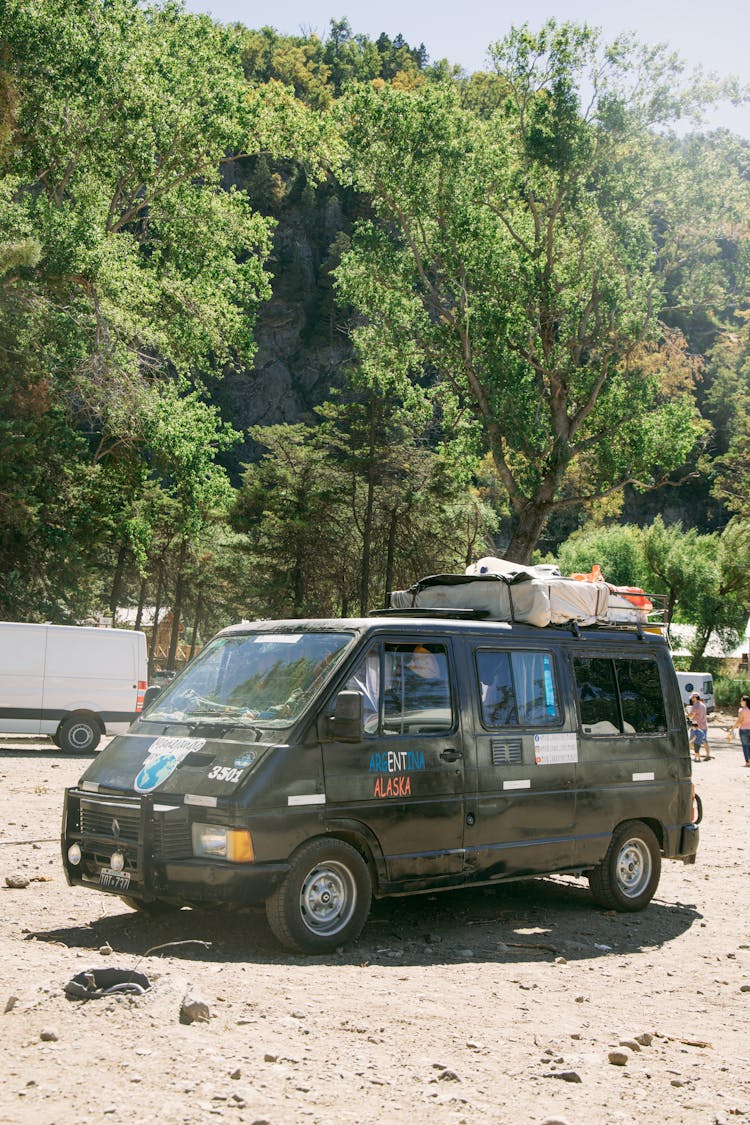 Black Van Parked On The Sandy Road 