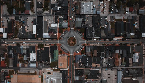 Cityscape with circle junction and roads between buildings