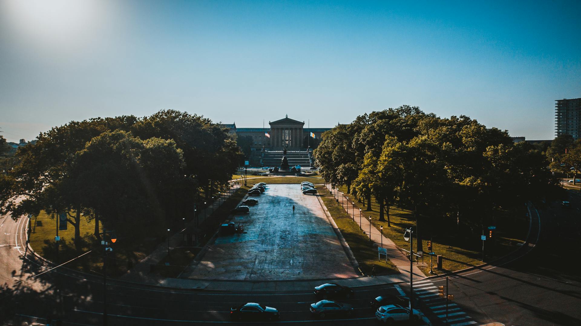 Aerial view of the iconic Philadelphia Museum of Art surrounded by lush greenery in summer.