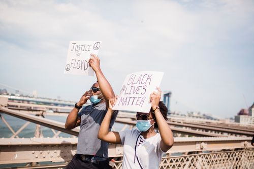 Free People holding signs during a Black Lives Matter protest on Brooklyn Bridge. Stock Photo