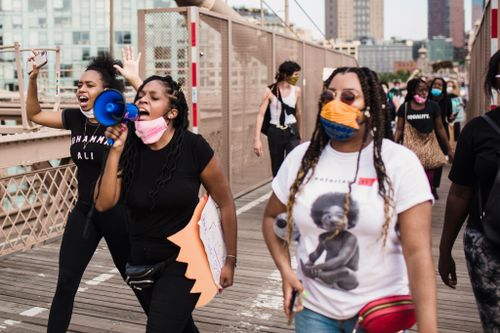 Free Group of diverse people gathered for a Black Lives Matter protest outdoors in the city. Stock Photo
