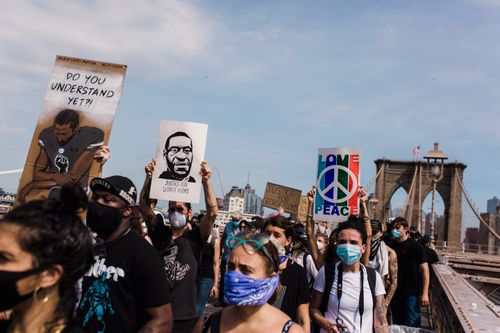 Free A diverse group of protesters march across the Brooklyn Bridge advocating for racial justice and equality. Stock Photo