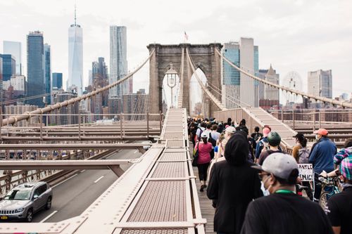 Free Crowd marching on Brooklyn Bridge for justice and solidarity protest. Stock Photo