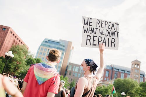 Free Woman Holding a Sign at a Protest Stock Photo