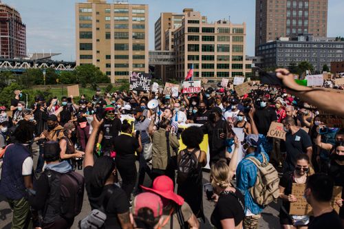 Free A large and diverse crowd gathers for a peaceful protest advocating for racial justice and equality in an urban setting. Stock Photo