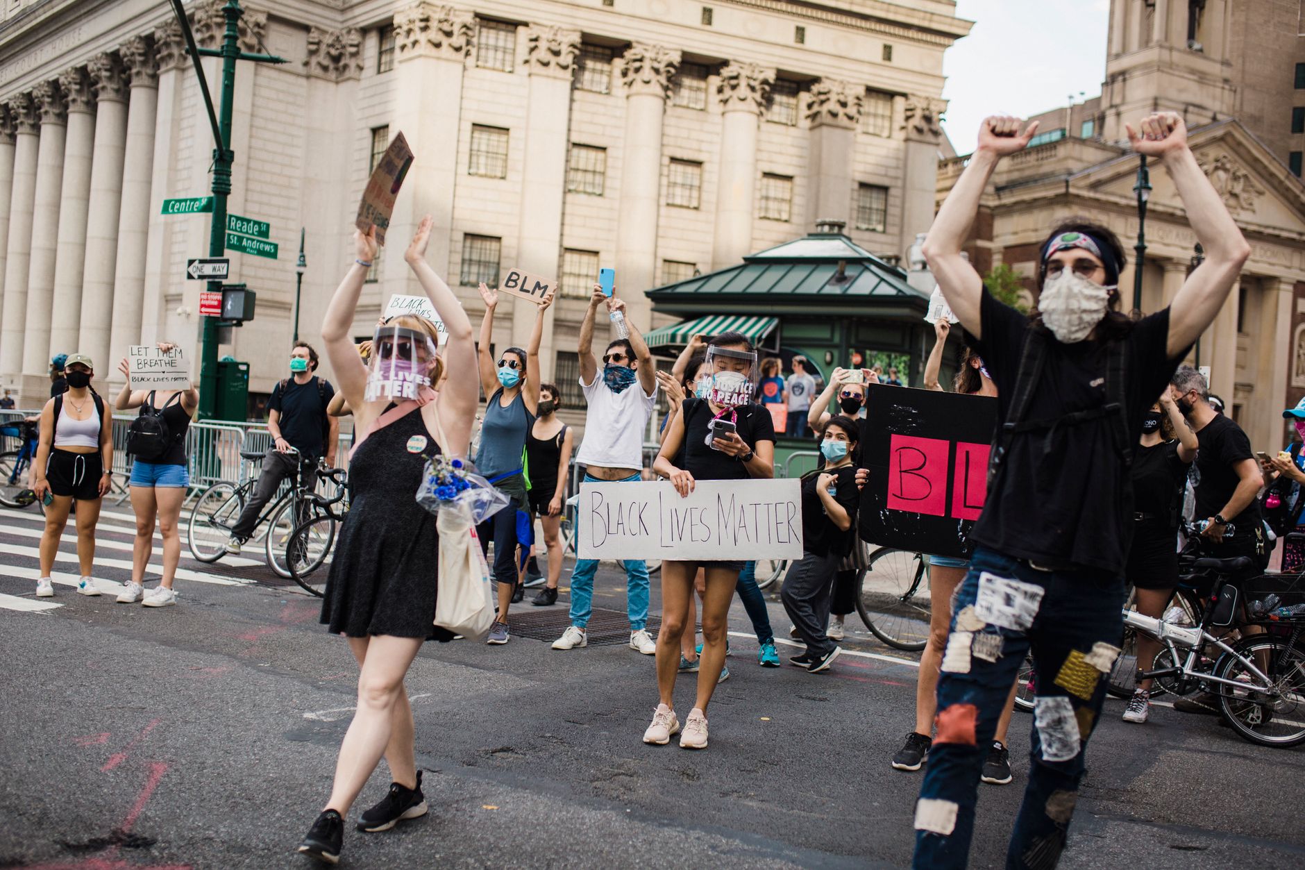 Protesters gather in the city for racial justice holding Black Lives Matter signs.