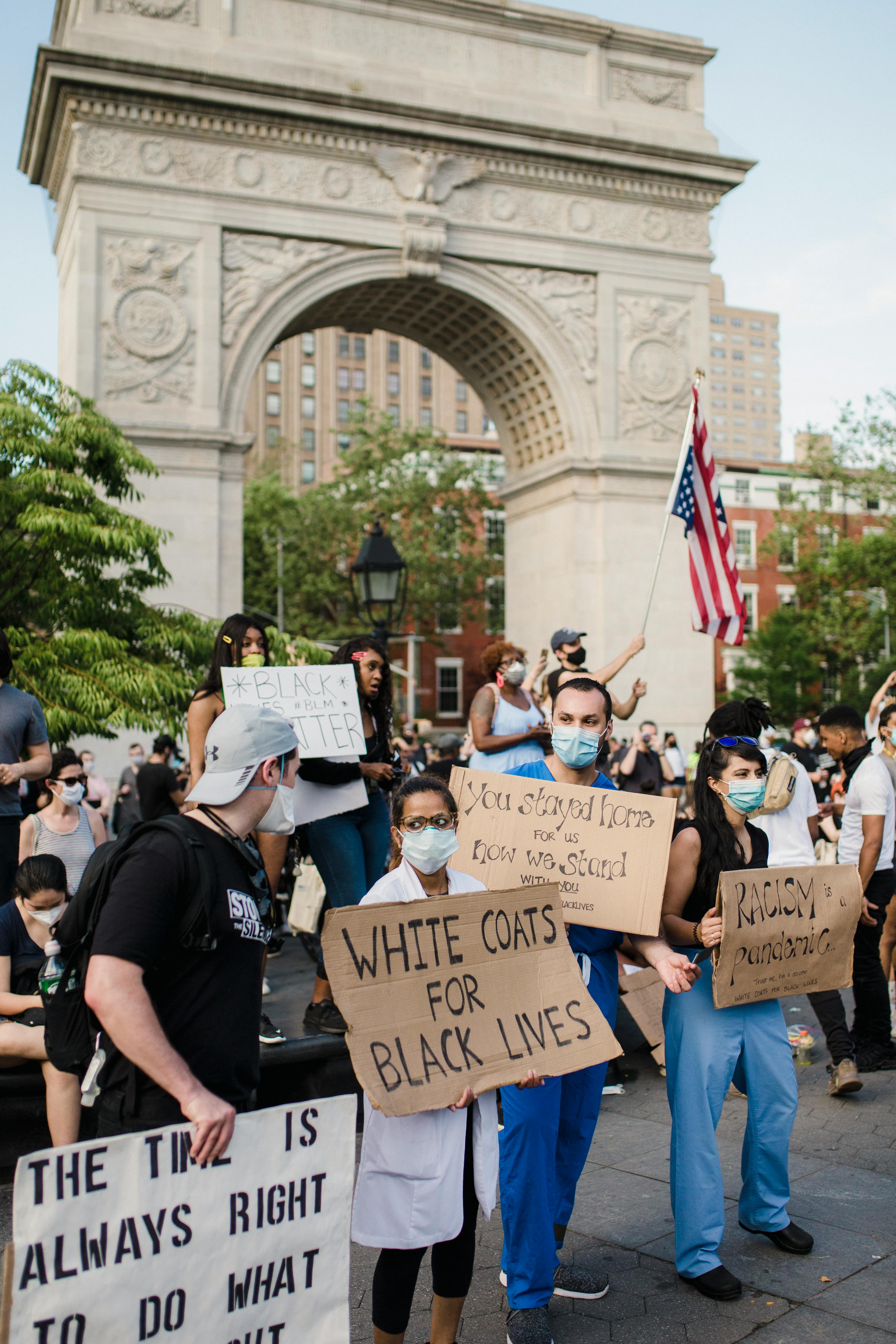 crowd of protesters holding signs