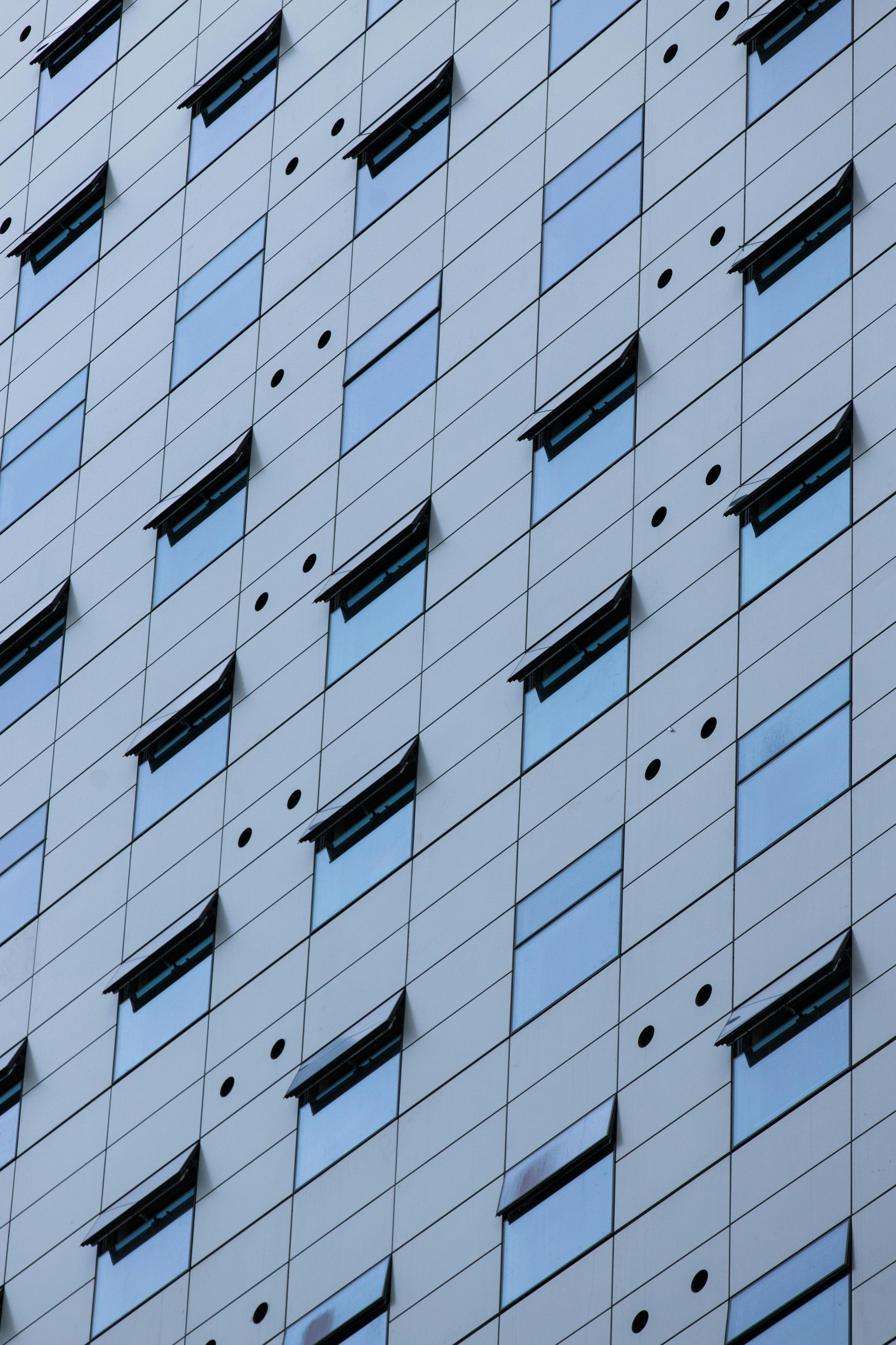 Close-up of a modern building facade with glass windows in Melbourne, Australia.