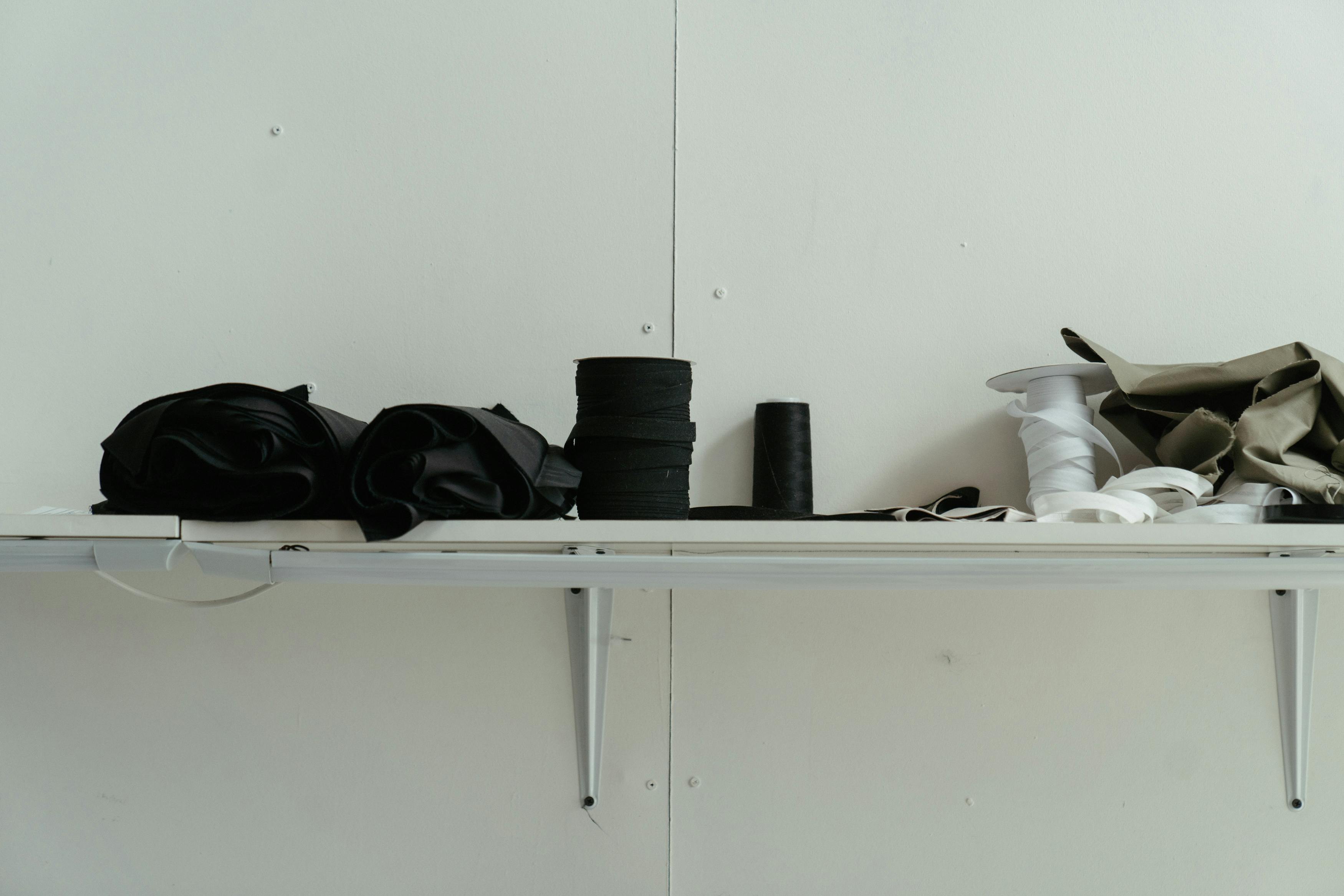 black camera lens on white wooden shelf