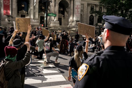 Free Crowd of Protesters Holding Signs and Kneeling Stock Photo