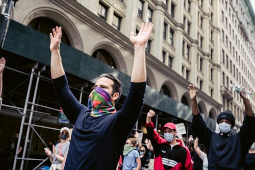 Free Protesters With Arms Raised Stock Photo