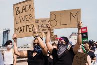 People Protesting and Holding Signs