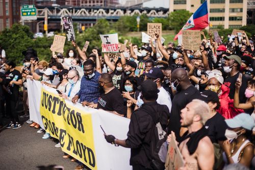 Free A large group of people protesting for justice in the city, demanding action for racial equality. Stock Photo