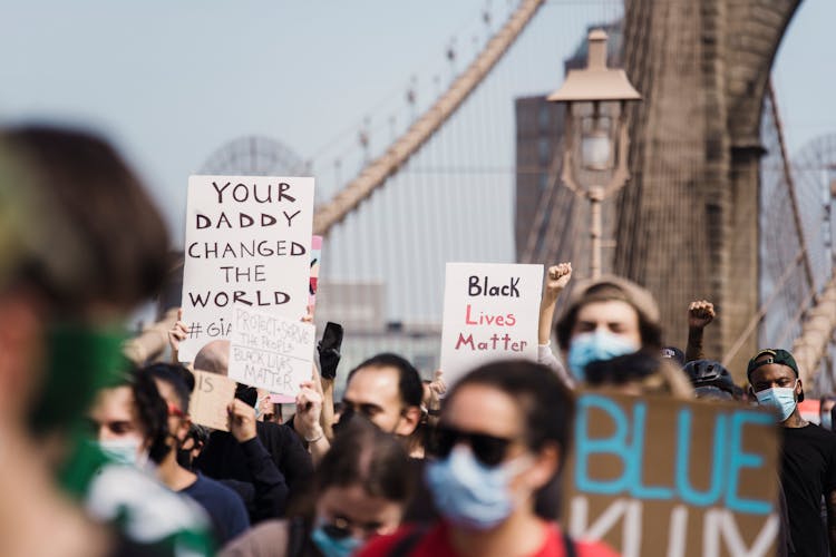 Crowd Of Protesters Holding Signs